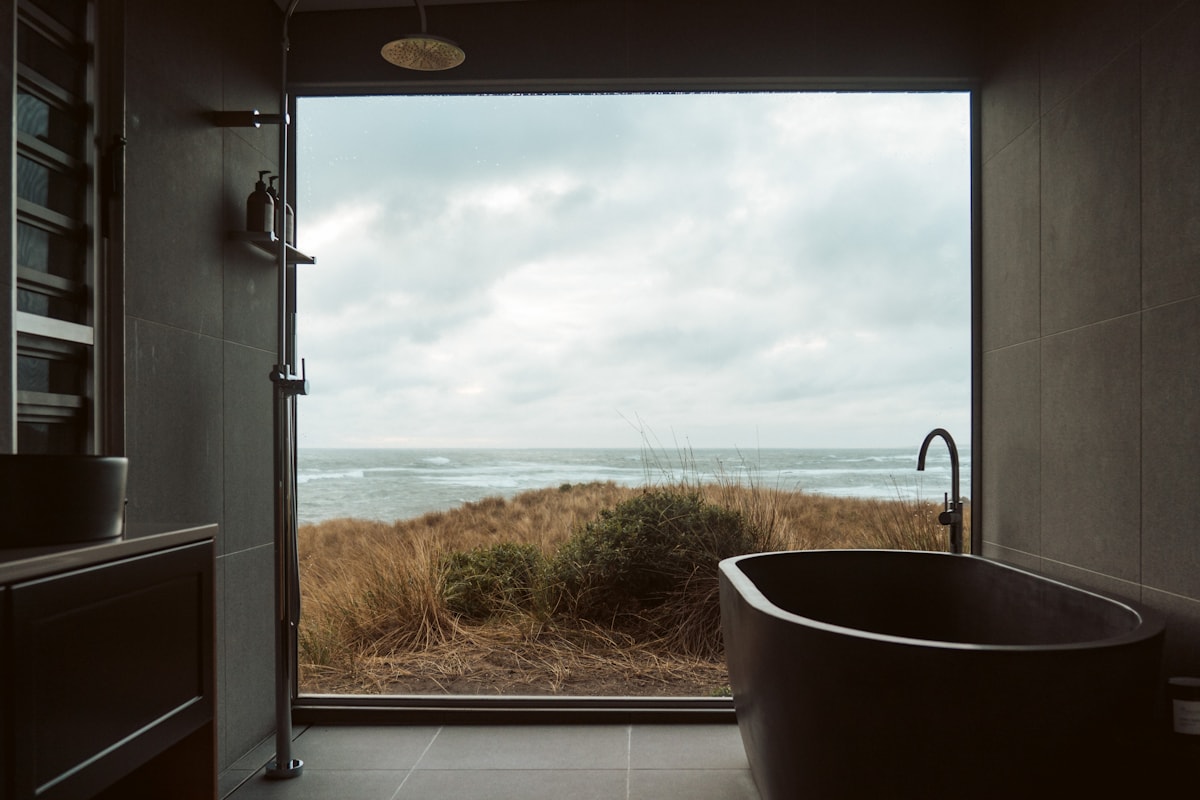 small washroom with antique mirror and worn wooden vanity
