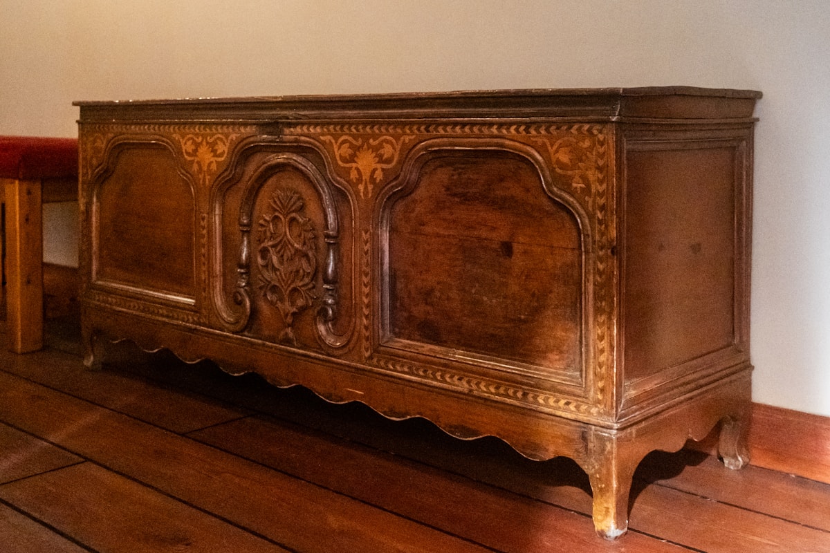 small parlor with a hand-tufted ottoman and a rush-seat chair